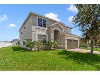 Two-story house with a large yard and driveway at 2839 Boating Blvd, Kissimmee, FL 34746
