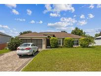 One-story house with a lush lawn and driveway at 3090 Tioga Ter, Deltona, FL 32738