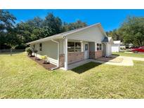 Charming one-story home with brick facade and landscaped yard at 213 Deborah Ave, Leesburg, FL 34748