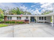 Ranch-style home with brick accents and landscaped yard at 905 Marabon Ave, Orlando, FL 32806