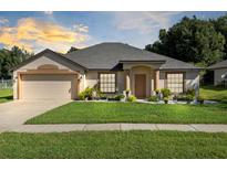 Single story home with attached garage and well-maintained lawn at 1831 Waterside Oaks Dr, Orange City, FL 32763