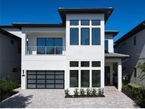 Modern two-story home with gray-brick facade and attached garage at 1020 Jack Nicklaus Ct, Kissimmee, FL 34747