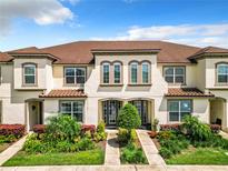 Beautiful 3-unit townhome building with landscaping at 8976 Amelia Downs Trl, Kissimmee, FL 34747