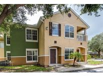 Two-story condo building with green and tan exterior at 4316 S Kirkman Rd # 1602, Orlando, FL 32811