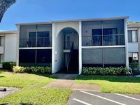 Two-story building exterior with screened balconies and stairs at 954 Courtyard Ln # 11, Orlando, FL 32825