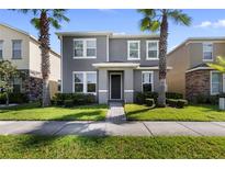 Two-story home with gray siding and landscaping at 5209 Creekside Park Ave, Orlando, FL 32811