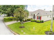 Single story home with a manicured lawn and mature trees at 441 Montara Dr, Davenport, FL 33897