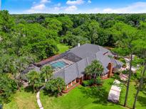 Aerial view of a luxurious home with a pool and lush landscaping at 2820 Jacana Ct, Longwood, FL 32779