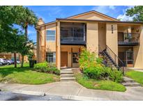 Inviting condo exterior with landscaping and parking at 4806 S Semoran Blvd # 201, Orlando, FL 32822