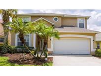 Two-story house with a two-car garage at 2615 Emerald Island Blvd, Kissimmee, FL 34747