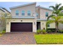 Modern two-story house with a dark brown garage door at 791 Pebble Beach Dr, Davenport, FL 33896