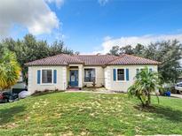 One-story house with a terracotta roof, blue shutters, and a fountain at 1250 Shorecrest Cir, Clermont, FL 34711