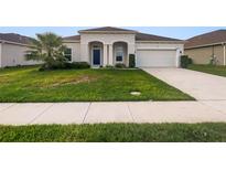 Two-story home with a two-car garage and attractive landscaping at 5408 Manchester Dr, St Cloud, FL 34771