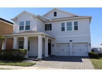 Two-story house with white exterior, double garage, and columns at 3062 Prelude Ln, Kissimmee, FL 34746