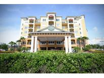 Resort-style building exterior with lush landscaping at 8125 Resort Village Dr # 3514, Orlando, FL 32821