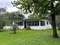 Charming ranch house with black shutters and well-maintained lawn at 800 Margaret St, Deland, FL 32720