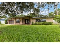 Ranch-style home with a well-maintained lawn at 20319 Macon Pkwy, Orlando, FL 32833