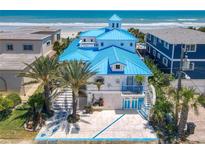 Oceanfront home with blue roof and unique landscaping at 2903 Hill St, New Smyrna Beach, FL 32169