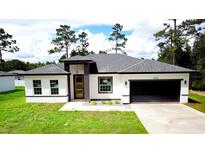 Modern one-story house with gray roof and attached garage at 5089 Sw 155Th Loop, Ocala, FL 34473