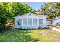 Newly renovated home with a sunroom and well-manicured lawn at 312 Lee Ne Ave, Winter Haven, FL 33881