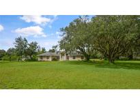 Single-story home with large yard and mature oak tree at 2101 Appy Ln, Apopka, FL 32712