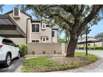 Tan house exterior with carport and landscaping at 1473 Farrindon Cir, Lake Mary, FL 32746