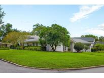 A charming mid-century modern home with a well-manicured lawn at 400 W Trotters Dr, Maitland, FL 32751