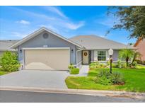 Single-story house with attached garage and landscaping at 535 Waterford Dr, Haines City, FL 33844