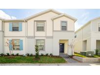 Two-story house with light-colored siding and blue shutters at 8930 Sydney Ave, Kissimmee, FL 34747