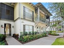 Exterior view of a two-story townhome with a walkway and landscaping at 610 Celebration Ave # 1209, Celebration, FL 34747