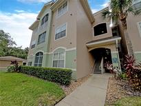 Exterior view of a condo building with landscaping at 4881 Cypress Woods Dr # 3213, Orlando, FL 32811