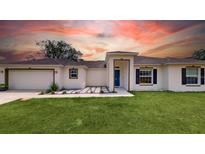 New construction home with a two-car garage and landscaped yard at 656 Cotulla Dr, Kissimmee, FL 34758