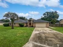 Brick house with mature landscaping, driveway and attached garage at 862 N 4Th Ave, Deltona, FL 32725
