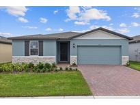 One-story home with two-car garage and landscaped front yard at 3166 Viceroy Ct, Poinciana, FL 34759