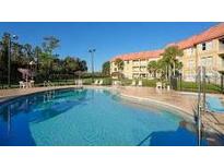 Inviting community pool with ample deck space for lounging at 6336 Parc Corniche Dr # 3303, Orlando, FL 32821