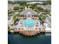 Inviting community pool with a spa, lounge chairs, and a clubhouse at 2601 Gala S Rd # 107, Kissimmee, FL 34746