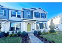 Two-story townhome with gray siding, lime green door, and landscaped yard at 772 Pilea St, Apopka, FL 32703