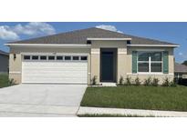 One-story home with white garage door and green shutters at 3758 Bluethread Way, Poinciana, FL 34759