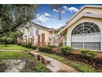 Two-story condo building with brick accents and lush landscaping at 5009 Laguna Bay Cir # 41, Kissimmee, FL 34746