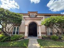 Two-story building exterior with columns and landscaping at 4842 Normandy Pl # 204C, Orlando, FL 32811