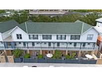 Aerial view of a townhome community showcasing multiple units with green roofs and private patios at 720 Celebration Ave # 220, Celebration, FL 34747