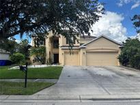Two-story house with a double car garage and landscaped yard at 3635 Daydream Pl, Saint Cloud, FL 34772
