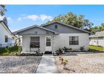 Cozy brick ranch home with gray trim and well-manicured landscaping at 142 Avenue F Sw, Winter Haven, FL 33880