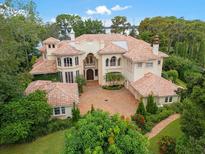 Luxury waterfront home with extensive landscaping at 9164 Point Cypress Dr, Orlando, FL 32836