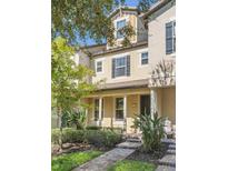 Two-story townhome with front porch and landscaping at 7290 Duxbury Ln, Winter Garden, FL 34787