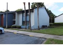 Two-story building exterior with landscaping and parking at 8 Escondido Cir # 79, Altamonte Springs, FL 32701