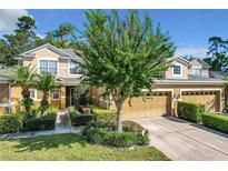 Two-story townhome with a two-car garage and manicured lawn at 452 Harbor Winds Ct, Winter Springs, FL 32708