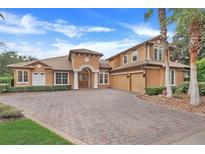 Two-story house with brick driveway and palm trees at 9106 Panzani Pl, Windermere, FL 34786