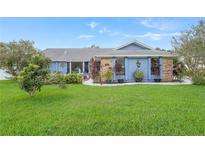 Cute light blue house with well-maintained lawn and landscaping at 8692 Vesta Ter, Orlando, FL 32825