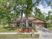 Brick ranch house with attached garage and landscaping at 1469 Grace Lake Cir, Longwood, FL 32750